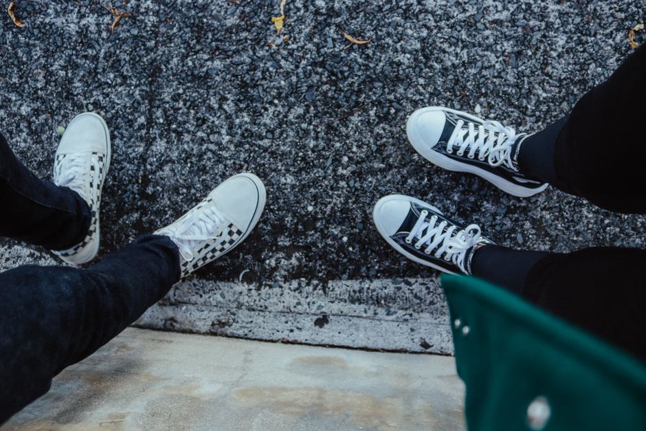 Casual sneakers from a top view on urban pavement, perfect for lifestyle scenes.