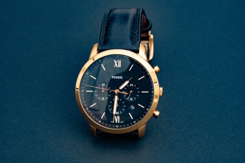 Luxury Fossil wristwatch with a black leather strap and gold casing, showcasing elegance and precision.