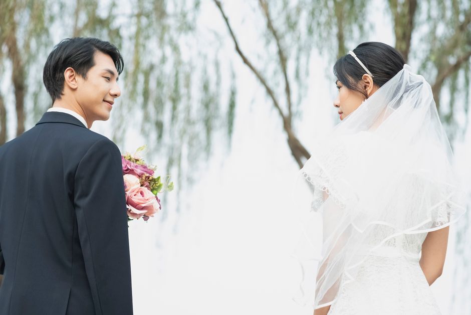 Bride and groom in a serene outdoor setting, capturing a romantic moment.